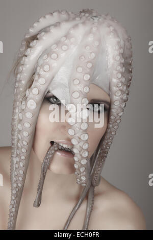 young woman with octopus on head Stock Photo