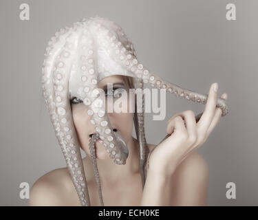 young woman with octopus on head Stock Photo