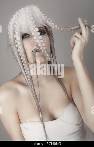 young woman with octopus on head Stock Photo