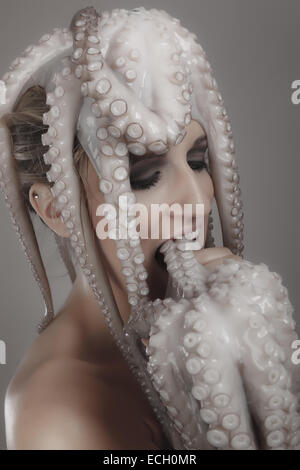 young woman with octopus on head Stock Photo