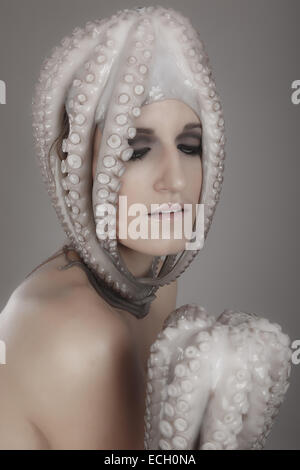 young woman with octopus on head Stock Photo