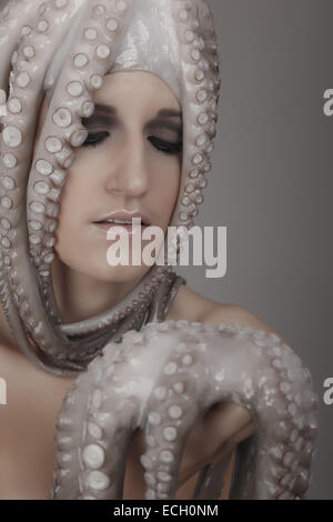 young woman with octopus on head Stock Photo