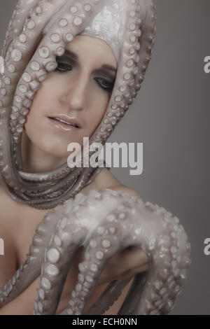 young woman with octopus on head Stock Photo