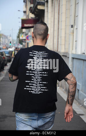 man with multi-lingual 'Beer please' T-shirt, Lille France Stock Photo