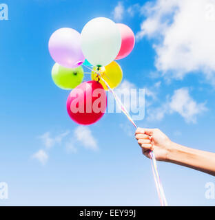 Young man holding balloons Stock Photo