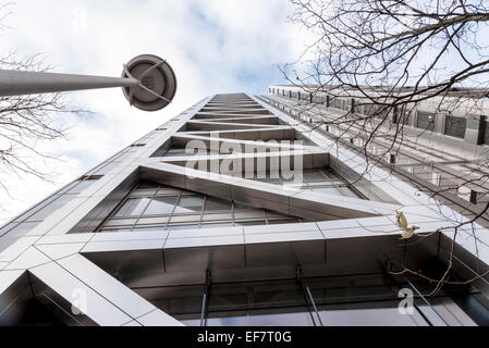 A view of a London building looking up towards the sky with lamp and trees Stock Photo