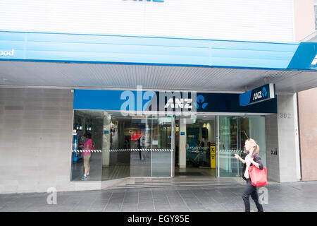 Lady walking past ANZ Australia and New Zealand bank  branch in Chatswood Sydney,NSW,  Australia Stock Photo