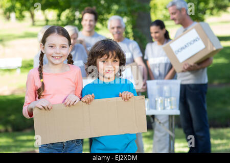 Happy siblings holding blank Stock Photo