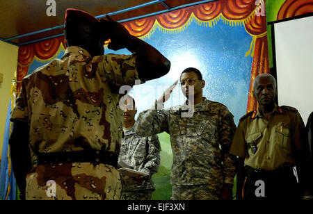 U.S. Army Brig. Gen. Sanford Holman renders a salute to a Djiboutian army soldier during a graduation ceremony March 11, 2008, at Forward Operating Location Ali Sabieh, Djibouti. U.S. Army Soldiers from the Guam Army National Guard's 3rd Platoon, Delta Company, 1st Battalion, 249th Infantry Regiment Light trained the Djiboutian soldiers on antiterrorism and counterterrorism tactics during a ten-week course covering 27 areas of offensive and defensive operations to better secure their borders against the threat of terrorism.  Tech. Sgt. Jeremy T. Lock Released Stock Photo