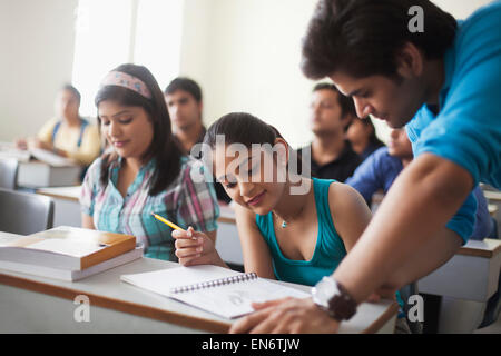 College students looking at notebook Stock Photo