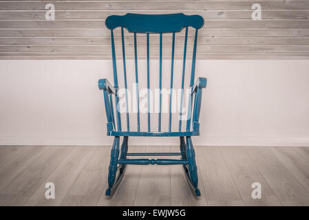 Blue rocking chair on a wooden floor Stock Photo