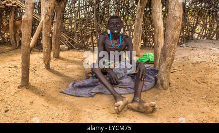 Old warrior from the african tribe Daasanach relaxing in his village. Stock Photo