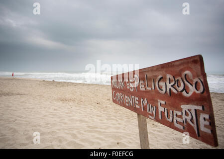 Sign in Spanish stating that it is dangerous to swim in Palomino, Colombia. Stock Photo