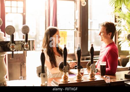 Couple talking in bar Stock Photo