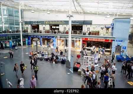 Customers at Manchester Piccadilly enjoy the  pop-up lounge to encourage them to take a few minutes to read, after TransPennine Stock Photo