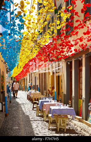 Street decorated with paper flowers on feast of Madeira, Funchal old town, Madeira Island, Portugal Stock Photo