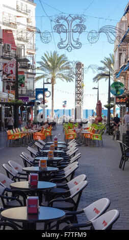 Benidorm Alicante Province Costa Blanca Spain. Street scene with empty cafe tables outside in pedestrian walkway Stock Photo