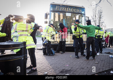 Kent, UK. 30th January, 2016. Anti-fascist protesters are searched by police. Far-Right nationalist groups violently clash with London anti-fascists at a Maidstone service station where coaches were also vandalised Credit:  Guy Corbishley/Alamy Live News Stock Photo