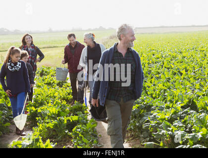 Multi-generation family walking in sunny vegetable garden Stock Photo