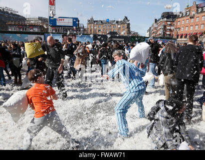 Copenhagen, Denmark, 2nd April, 2016. Massive pillow fights in the City Hall Square in Copenhagen on the 7th International Pillow Fight Day attract many hundreds of participants and spectators of all ages on this sunny Saturday afternoon. More than 100 cities around the world take part in this spectacular and funny annual event. Behind the idea is the Urban Playground Movement, a playful part of the larger public space movement. Credit:  Niels Quist/Alamy Live News Stock Photo