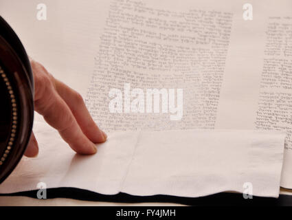 Close Up of Torah Scroll and Hand Stock Photo