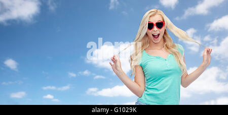 happy young woman in heart shape sunglasses Stock Photo