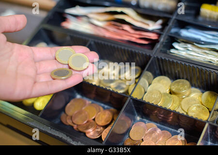 coins in the cash register Stock Photo