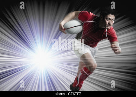 Portrait of Japanese rugby player running with ball Stock Photo