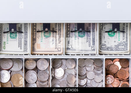 Close up on American currency in cash drawer consisting of pennies, dimes, nickels, quarters and various paper bills Stock Photo