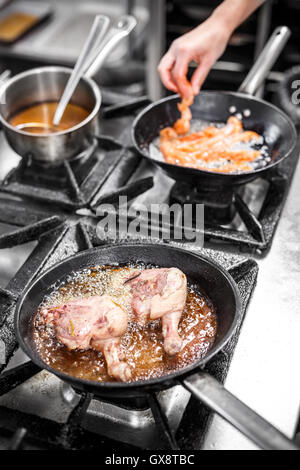 Two goose drumstick frying in a pan Stock Photo