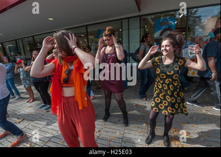 London, UK. 24th September 2016. Housing campaigners Focus E15 dance at the party at the weekly street stall on Stratford Broadway to celebrate the third anniversary of the fight against Newham Council. The 29 young mothers stood together to fight against their eviction from the Focus E15 hostel, refusing to accept being moved out of London, away from families and communities and demanding to be allowed to continue to live in the area they knew as home. Their lively campaign forced Newham to rehouse them locally, but they continue to campaign for others, bringing issues of social cleansing and Stock Photo