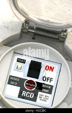 wet discarded electrical safety trip switch Stock Photo