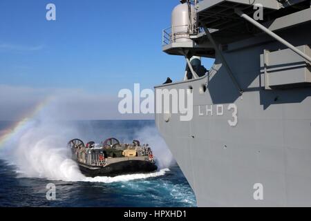 A landing craft air cushion from Assault Craft Unit 4 approaches the amphibious assault ship USS Kearsarg, January 23, 2013. Image courtesy Corbin J Shea/US Navy. Stock Photo