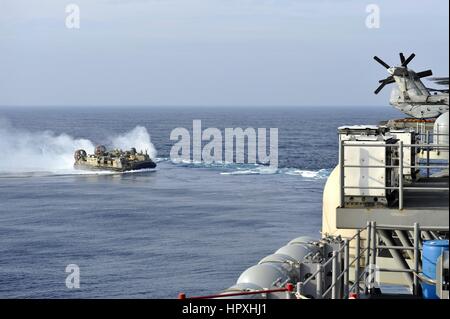 A landing craft air cushion approaches the stern of the amphibious assault ship USS Bonhomme Richard, East China Sea, February 2, 2013. Image courtesy US Navy. Stock Photo