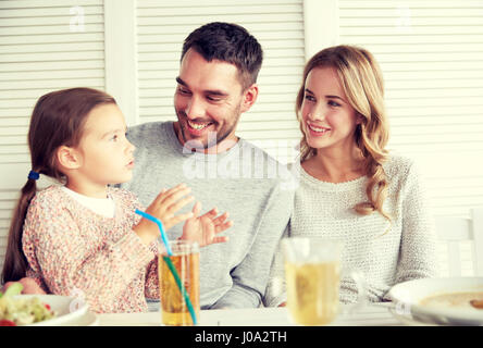 happy family having dinner at restaurant or cafe Stock Photo