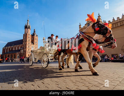 Horse Carriage with St. Mary Basilica in the background, Main Market Square, Cracow, Lesser Poland Voivodeship, Poland, Europe Stock Photo