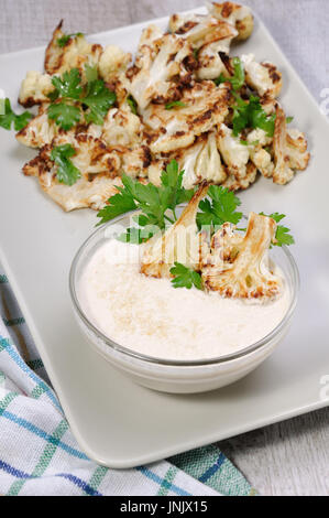 Roasted cauliflower with tahini sauce (sesame paste) Stock Photo