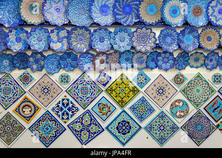 ISFAHAN, IRAN - OCTOBER 18, 2014: glazed tiles and iranian souvenirs in the Bazaar of Isfahan Stock Photo