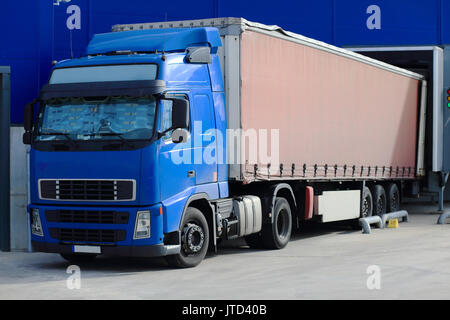 Truck at loading docks close-up. Cargo transportation theme. Stock Photo