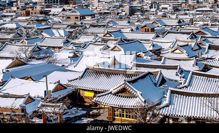 Roof of Jeonju traditional Korean village covered with snow, Jeonju Hanok village in winter, South Korea. Stock Photo