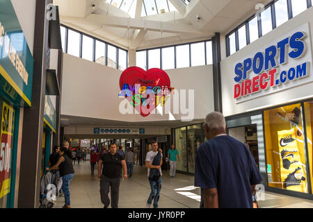 View of shops in The Mall, Walthamstow - with neon light in the style of God's Own Junkyard reading 'this is Awesomestow' Stock Photo