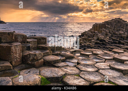 The Giant's Causeway is an area of about 40,000 interlocking basalt columns, the result of an ancient volcanic eruption. It is located in County Antri Stock Photo