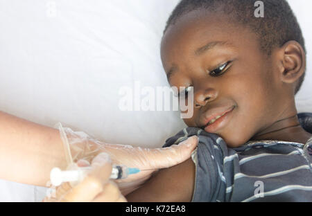 Black African boy gets a medical injection as a healthcare project for Africa Stock Photo