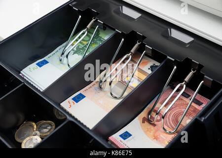 Close-up Of Coins And Banknote In Open Cash Register Stock Photo