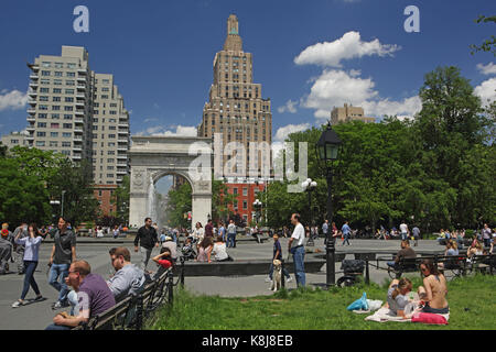 New York, NY, USA - June 1, 2017: Tourists and New York locals alike enjoy a sunny day in Washington Square Park Stock Photo