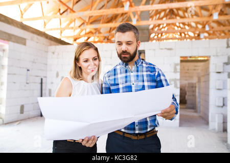 Young couple at the construction site. Stock Photo