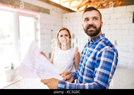 Young couple at the construction site. Stock Photo