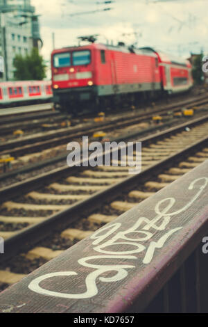 Blurred arrived red train und rails in front. Hamburg Stock Photo