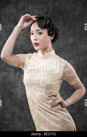 Young woman in retro-style oriental clothes posing Stock Photo