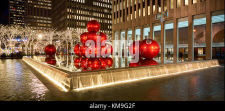 Giant red Christmas ornaments on 6th Avenue with holiday season decorations. Avenue of the Americas, Midtown Manhattan, New York City Stock Photo